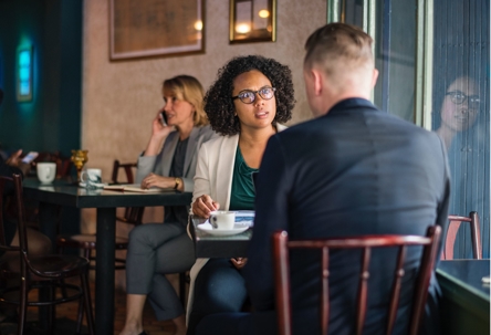 A woman and a man having a conversation at a restaurant