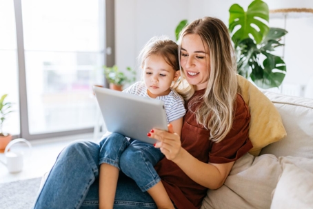 Mother and daughter using a digital tablet together.