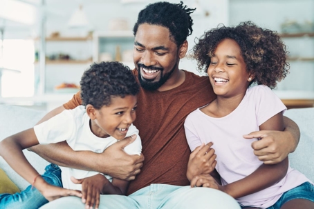 father playing with his daughter and son at home