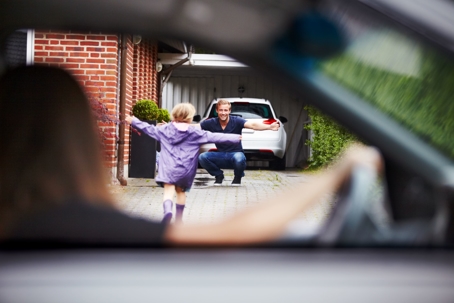 father waiting with open arms as his child runs toward him