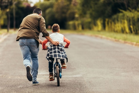 Dad with son riding bike