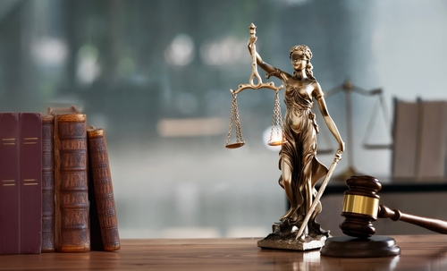 Legal and law concept. Statue of Lady Justice with scales of justice and wooden judge gavel on wooden table. Panoramic image statue of lady justice.