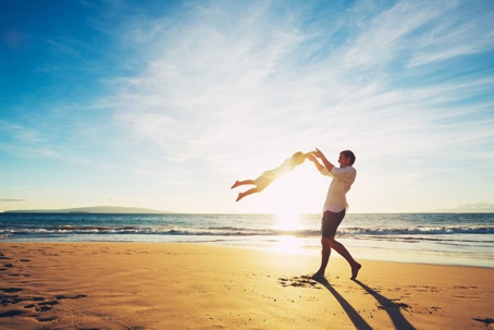 Father and Son Playing on the Beach at Sunset