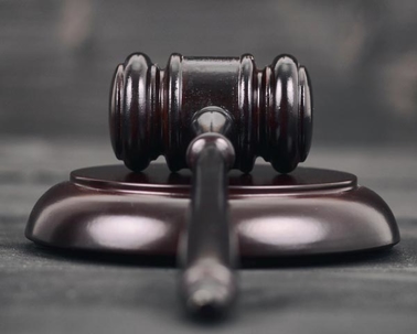 judge's gavel on a grey background