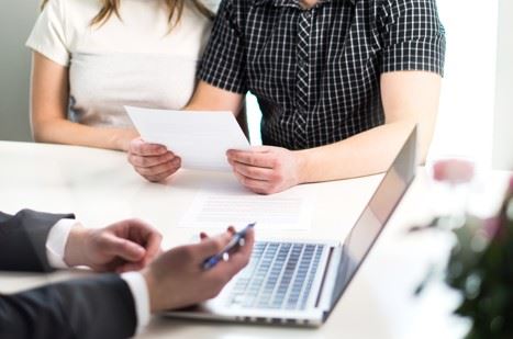 couple doing prenup paperwork with attorney